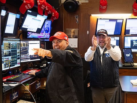 Traders wearing Trump hats celebrate the re-election of US President-elect Donald Trump on the floor of the New York Stock Exchange (NYSE) in New York, US, on Wednesday, Nov. 6, 2024.