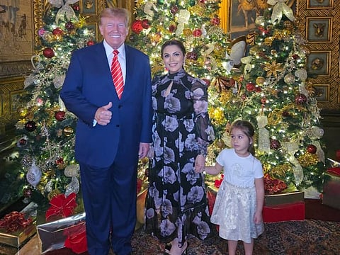 Donald Trump, Dunia Tayarer and Alia Mohammad Almusharakh at the Christmas dinner in 2023.