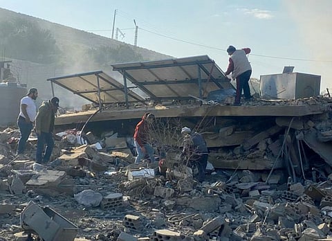 People inspect the damage at the site of an Israeli airstrike that targeted the village of Al Ain near Baalbek in Lebanon's eastern Bekaa Valley, on November 7, 2024.