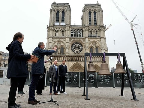 The Rector-Archbishop of Notre-Dame cathedral Monseigneur Olivier Ribadeau Dumas (2-L), next to the Director of the Cornille Havard bell foundry Paul Bergamo (C) and the French President of the Paris 2024 Olympics and Paralympics Organising Committee (COJO) Tony Estanguet (R), blesses the three new bells, including the bell used during the Paris Olympic Games, set to be placed into Paris' Notre-Dame cathedral on November 7, 2024, one month before it is due to reopen and five years after a devastating fire.