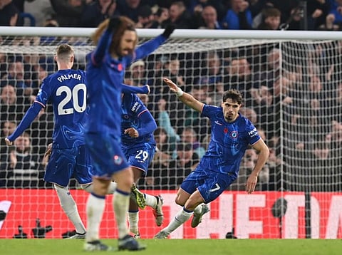 Chelsea's Portuguese midfielder Pedro Neto (right) celebrates after scoring their first goal during the English Premier League football match against Arsenal at Stamford Bridge in London on Sunday.
