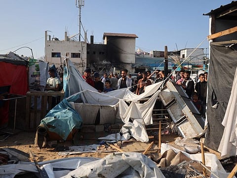 Displaced Palestinians check the damage following an Israeli strike that hit tents set up in the vicinity of the Al Aqsa Martyrs hospital in Deir Al Balah in the central Gaza Strip on November 9, 2024.