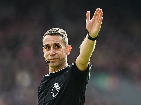 Referee David Coote gestures during the English Premier League football match between Liverpool and Brighton and Hove Albion at Anfield in Liverpool, north west England on March 31.