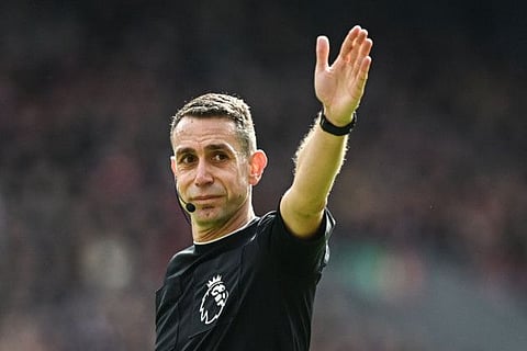 Referee David Coote gestures during the English Premier League football match between Liverpool and Brighton and Hove Albion at Anfield in Liverpool, north west England on March 31.