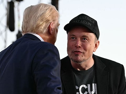 Tesla CEO Elon Musk (R) with former US President and Republican presidential candidate Donald Trump during a campaign rally on October 5, 2024.