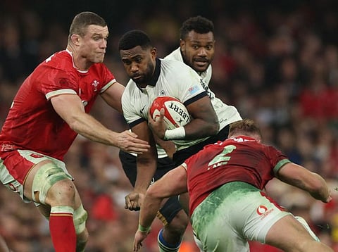 Fiji's full-back Vuate Karawalevu (centre) is tackled by Wales' lock Will Rowlands and hooker Dewi Lake (right) during the Autumn Nations Series International rugby union test match at the Principality Stadium, in Cardiff on November 10.