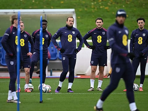England's striker Harry Kane (centre) stands with teammates during a training session at St George's Park in Burton-on-Trent, central England, on Tuesday.