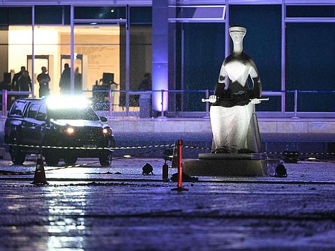 Police guard the crime scene where a man died after an explosion in front of Brazil's Supreme Federal Court in Brasilia, Brazil.