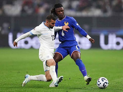 Israel's Mahmoud Jaber, left, fights for the ball with France's Eduardo Camavinga during the UEFA Nations League League A, Group A2 football match between France and Israel at The Stade de France stadium in Saint-Denis.