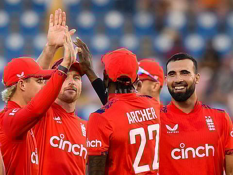 Saqib Mahmood (right) of England celebrates the dismissal of Evin Lewis of the West Indies during the third T20 in Saint Lucia on Thursday.