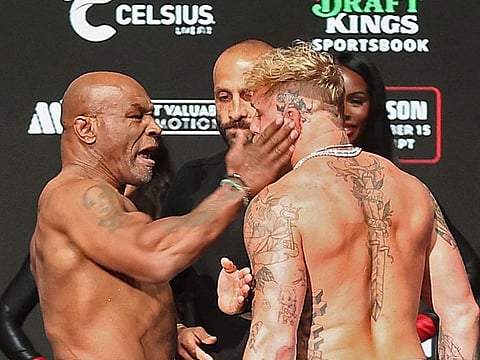 Mike Tyson slaps Jake Paul as they face off during their ceremonial weigh-in at The Pavilion at Toyota Music Factory on November 14, 2024 in Irving, Texas.