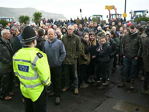 Farmers gather on the Promenade, outside the venue of the Welsh Labour Party conference in Llandudno, north-west Wales on November 16, 2024, as Britain's Prime Minister Keir Starmer speaks to delegates inside.