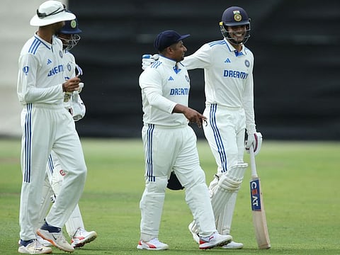 Indian players, Sarfraz Khan (centre) and Shubman Gill walk back towards the dressing room during the internal practice match between India and India A cricket teams at the WACA in Perth on Saturday.