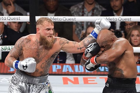 Jake Paul (left) punches Mike Tyson during their heavyweight bout at AT&T Stadium.