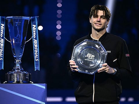 USA's Taylor Fritz poses with his trophy after being defeated by Italy's Jannik Sinner during their final match at the ATP Finals tennis tournament in Turin on Sunday.