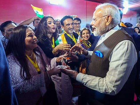 Prime Minister Narendra Modi receives a warm welcome from members of the Indian community upon his arrival on the first leg of his three-nation visit, in Abuja, Nigeria, on Sunday.