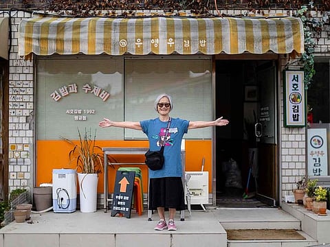 K-drama tourist Yvonne poses outside local gimbap franchise, Seoho Gimbap, featured in legal K-drama “Extraordinary Attorney Woo”, in Suwon