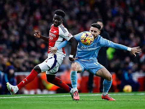 Arsenal's midfielder Bukayo Saka (L) fights for the ball with Nottingham Forest's defender Alex Moreno during the English Premier League football match at the Emirates Stadium in London on November 23, 2024.