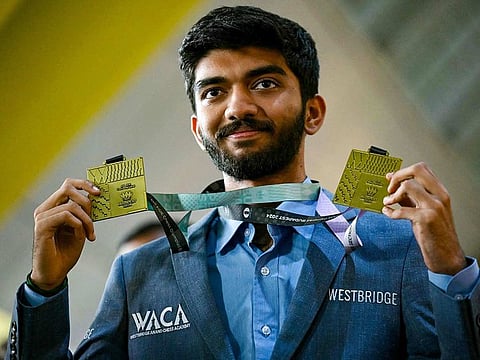 File photo: Gold medallist grandmaster Gukesh Dommaraju shows his medals upon his arrival at the Chennai International Airport in Chennai on September 24, 2024, after winning the 45th FIDE Chess Olympiad Budapest 2024.