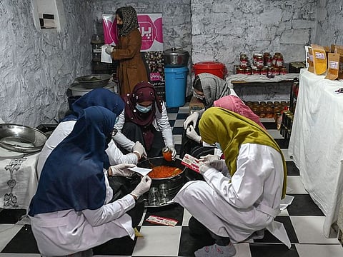 Afghan women prepare jams and pickles at the Parnivan food production company inside the basement of a house in Kabul. Many women have launched small businesses in the past three years to meet their own needs and support other Afghan women.