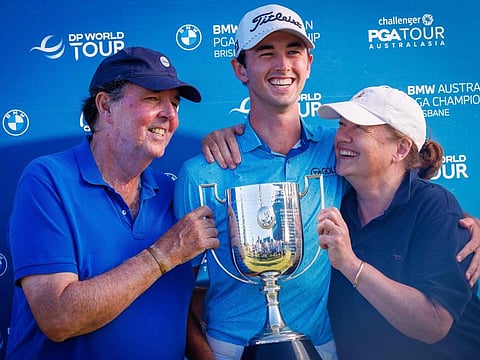 Elvis Smylie of Australia (centre) holds the cup with his parents Peter and Liz after winning the Australian PGA Championship at Royal Queensland Golf Club in Brisbane on Sunday.