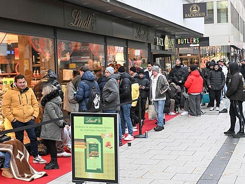 Customers line-up in front of a branch of chocolate producer Lindt before the sale of 100 Dubai Chocolate bars starts in Stuttgart, southern Germany, on November 15, 2024.