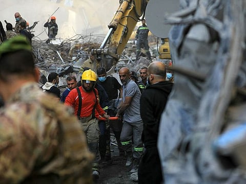 Rescuers remove the body of a victim extracted from the rubble of a levelled building, following an overnight Israeli airstrike that targeted Beiruts Basta neighbourhood on November 23, 2024.