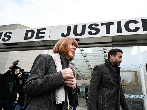 Gisele Pelicot looks on (C) next to her lawyer Antoine Camus (R) as she leaves the Avignon courthouse during the trial of her former partner Dominique Pelicot.