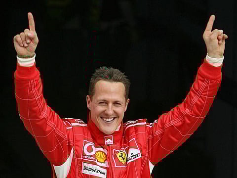 Michael Schumacher celebrates after taking the pole position at the end of the qualifying session for the Bahrain Formula One Grand Prix in 2006.