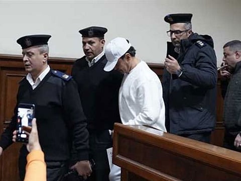 Al Soghayar is led by police during a trial hearing in Cairo.