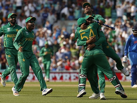 Pakistan's players celebrate their victory over India on the pitch after the ICC Champions Trophy final cricket match at The Oval in London on June 18, 2017.