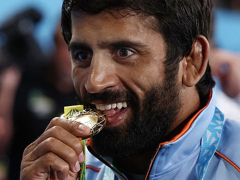 File photo: Gold medalist India's Bajrang Punia reacts during the medal ceremony for men's 65kg gold medal wrestling on day nine of the Commonwealth Games at Coventry Arena in Coventry, central England, on August 5, 2022.
