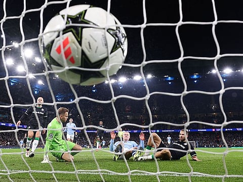 Manchester City's striker Erling Haaland (C) shoots and scores his team third goal during the UEFA Champions League football match against Feyenoord at the Etihad Stadium in Manchester, north west England, on November 26, 2024.