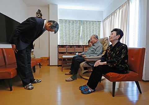 Hideo Yamada, chief prosecutor of the Shizuoka District Public Prosecutors Office, bows to apologise to Iwao Hakamada  after his acquittal was confirmed in a retrial in October, as his sister Hideko Hakamada looks on, in the city of Hamamatsu, Shizuoka prefecture on November 27, 2024.