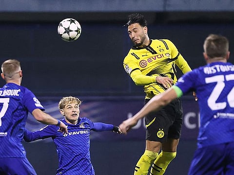 Borussia Dortmund's defender Rami Bensebaini (C) heads the ball and scores his team's second goal during the UEFA Champions League match against GNK Dinamo Zagreb at the Maksimir Stadium in Zagreb, on November 27, 2024.