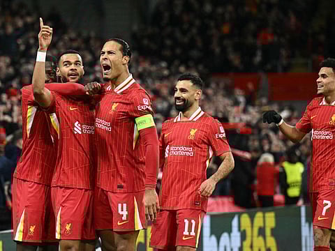 Liverpool's Dutch striker Cody Gakpo (2L) celebrates scoring the team's second goal during the Uefa Champions League football match against Real Madrid at Anfield in Liverpool, north west England on Wednesday.