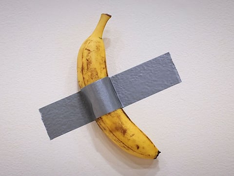 Italian visual artist Maurizio Cattelan's duct-taped Banana entitled "Comedian," is on display during a media preview at Sotheby's in New York, on November 8, 2024.