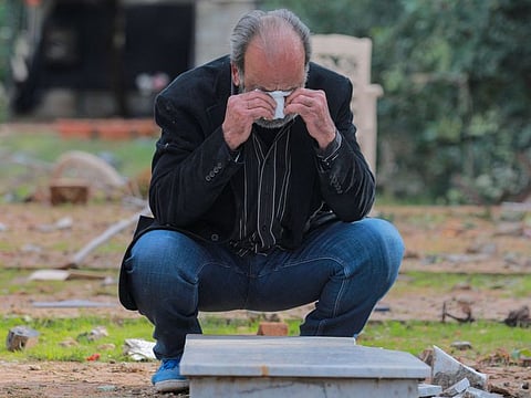 Displaced Lebanese Mohammed Abbas, from the Bekaa valley, reacts on November 28, 2024, as he finds the tomb of his brother who was killed during the hostilities between Israel and Hezbollah and was buried hastily in Beirut's Shayah cemetery.