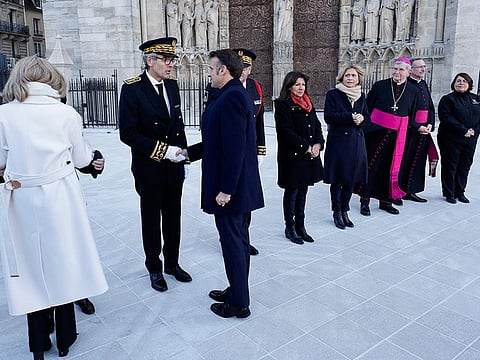 French President Emmanuel Macron (3L) shakes hands with Ile-de-France prefect Marc Guillaume (2L) next to Paris' prefect Laurent Nunez (4L), Paris' mayor Anne Hiladgo (5L), Ile-de-France's President Valerie Pecresse (4R) and Paris' archbishop Laurent Ulrich (3R) as he arrives to visit Notre-Dame de Paris cathedral in Paris, on November 29, 2024.