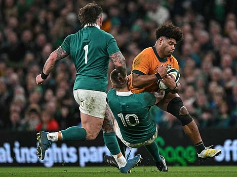 Australia's flanker Rob Valetini (R) is tackled by Ireland's fly-half Sam Prendergast (C) during the International rugby union test match between Ireland and Australia at the Aviva Stadium in Dublin.