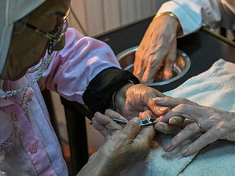 A client receives a manicure at Madam Lucie's manicure shop in downtown Cairo.
