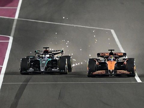 Mercedes' British driver George Russell and McLaren's Australian driver Oscar Piastri compete during the sprint race ahead of the Qatari Formula One Grand Prix at the Lusail International Circuit in Lusail, Doha, on Saturday.