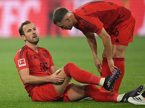 Bayern Munich's English forward Harry Kane speaks with midfielder Joshua Kimmich after an injury during the German first division Bundesliga football match against BVB Borussia Dortmund in Dortmund, western Germany on Saturday..