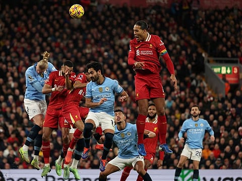 Liverpool's Dutch defender Virgil van Dijk jumps to head the ball during the English Premier League football match against Manchester City at Anfield in Liverpool, north west England on Sunday.