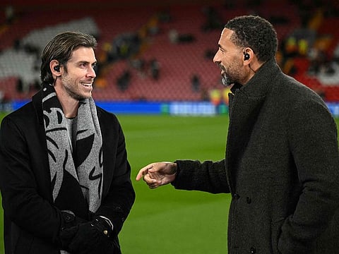Former Real Madrid and Wales footballer Gareth Bale (L) talks to former Manchester United player and TV pundit Rio Ferdinand ahead of the UEFA Champions League football match between Liverpool and Real Madrid at Anfield in Liverpool, north west England on November 27, 2024.