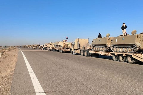 A handout picture released by the Iraq's Defence Ministry shows Iraqi military equipment being transported towards the border with Syria on December 2, 2024. Iraqi Prime Minister Mohammed Shia Al Sudani told Al Assad on November 30, that his country's security was key to the stability of the whole region.