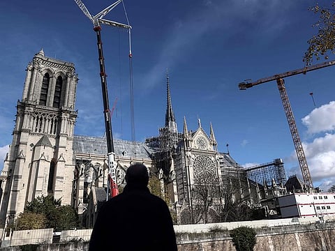 A man looks at Notre Dame de Paris cathedral, in Paris on December 2, 2024.
