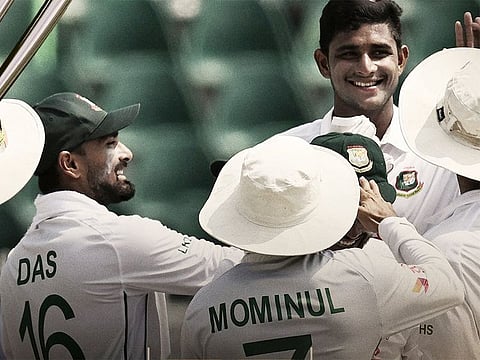 Nahid Rana is congratulated by teammates.
