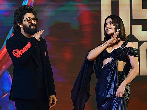 Indian actor Allu Arjun and actress Rashmika Mandanna pose for photos as they attend a promotional event of their film 'Pushpa 2: The Rule' in Mumbai on November 29, 2024.