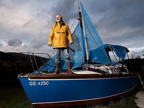 Frenchman Bernard Poitau poses on his boat "Anticylone" as he takes part in the Vendee Globe, the solo non-stop round the world yacht race, on the Virtual Regatta sailing race simulator, spending 22 hours a day on a boat on slipways in his garden to raise charity funds in Saint-Julien-Molin-Molette, central-eastern France.